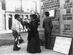 In front of the Lifeboat House c1890. A sign for St Clements Caves may be seen and a carriage passes the Rising Sun
